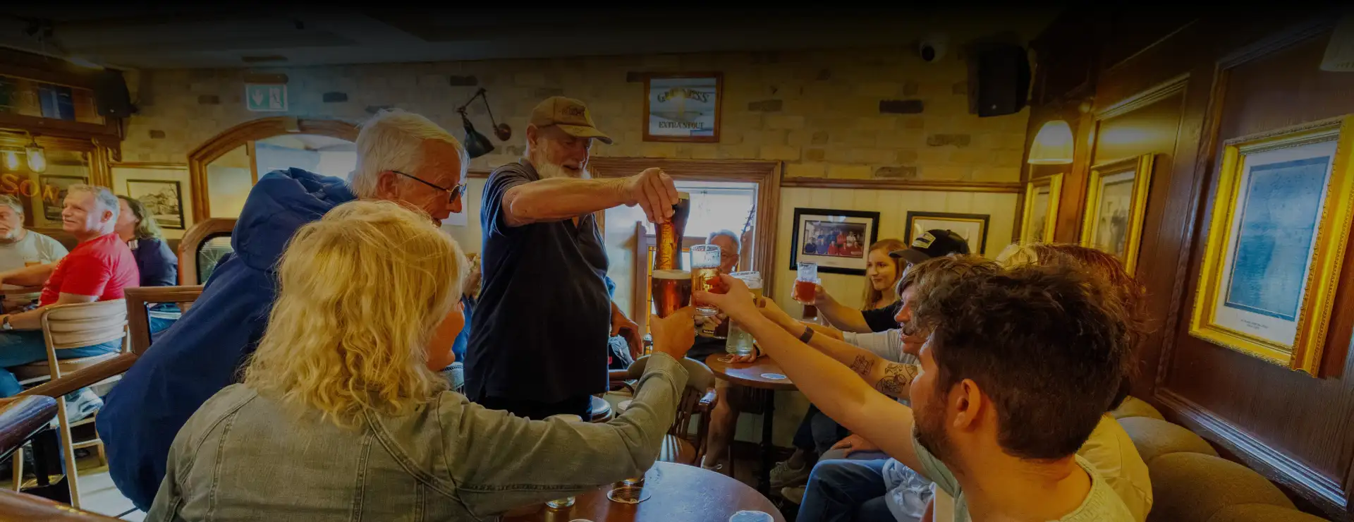 Group of people having drinks at Malzard's banner